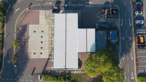 Top-down timelapse of gas station and car wash with cars, long shadows and Stock Footage 318160075