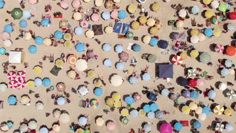 Top Down Timelapse View of Sun Umbrellas and People at the Beach During Summer Stock Footage 134496502