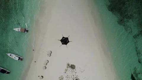 Top-down tracking drone shot over sandbar at Cayo de Agua, showing beach tents 스톡 동영상 336707198
