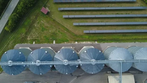 Top-Down Tracking Flight Over Grain Silos and Solar Farm – Bavaria Stock Footage 343891949