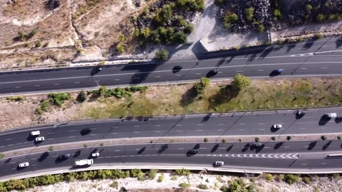 Top down tracking shot of a busy highway and intersection 動画素材 318024362