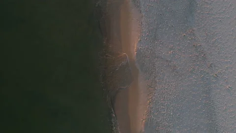 Top Down Tracking Shot of the Ocean Shore at Sunset Stock Footage 136485587