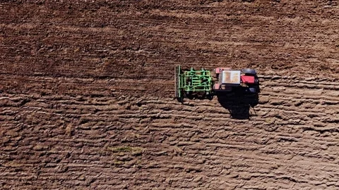 Top Down Tractor View, Stork Flies Into Sunny Frame Over Freshly Cultivated Soil Stock Footage 344078351
