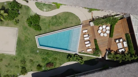 Top down triangular pool with deck and lounge area Prea beach resort Ceara Stock Footage 334574199