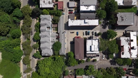 Top down tripod aerial perspective over residential buildings roofs and streets, Stock Footage 337894448