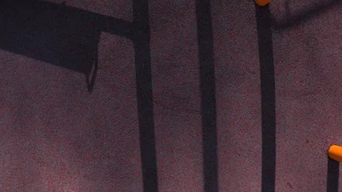 Top-down under a golden yellow jungle gym on a sunny day; tilt, boom up, pan 動画素材 333493492
