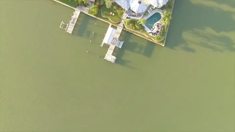 Top-down vertical aerial of Clearwater Beach homes at sunrise during golden hour Stock Footage 326021167