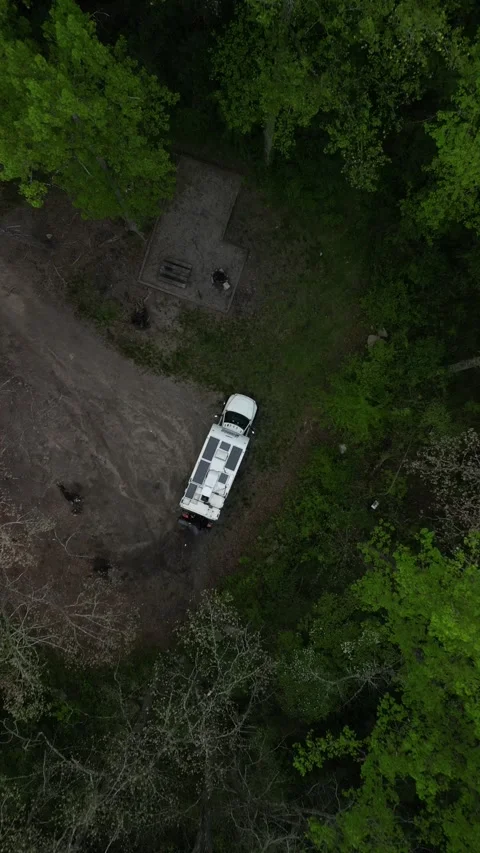 Top down vertical circling ascending aerial of RV camping in North Carolina Stock Footage 307563906