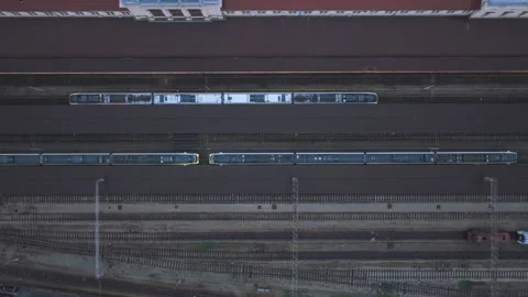 Top-down vertical drone rise over trains and railway tracks at station Stock Footage 321647126