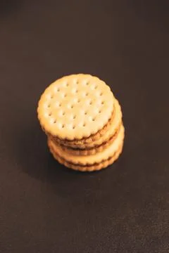 A top down vertical portrait of round delicious cookies with holes stacked .. Stock Photos