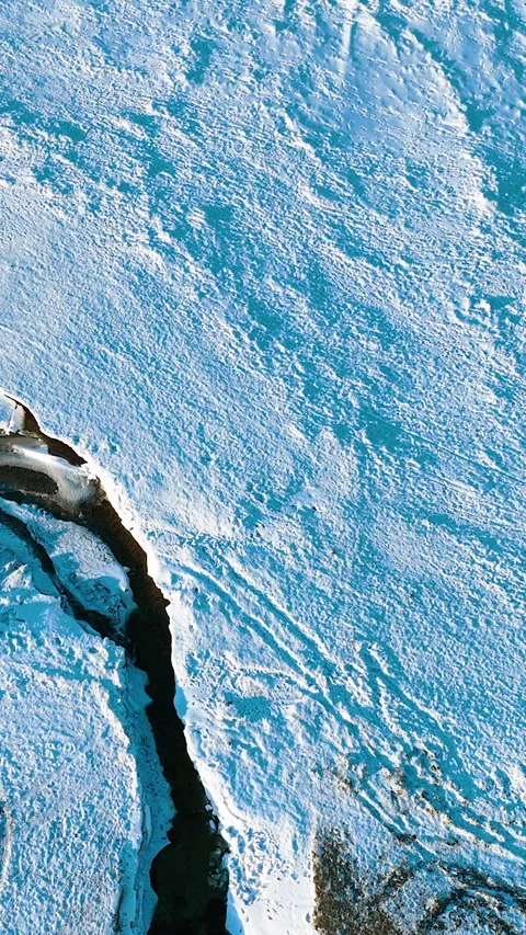 Top Down Vertical Shot Of Winter River Flowing Through Snow Stock Footage 337798835