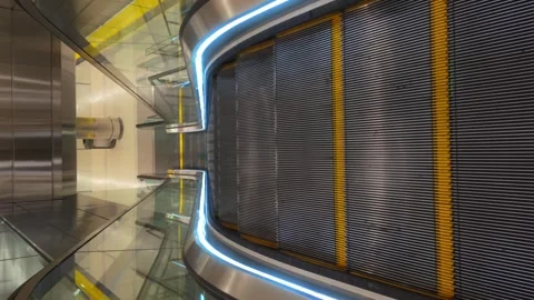 A top down vertical video of a moving escalator. Taken in an empty and Video stock 280230246