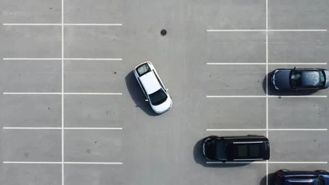 Top down video car reversing in a parking place Stock Footage 247619519