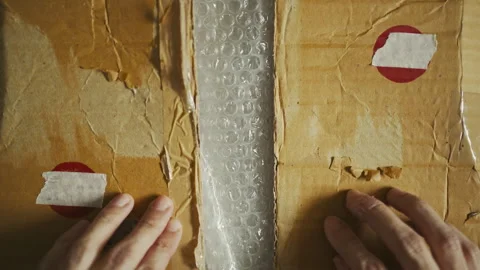 Top-Down Video of Packaging Materials with Recycled Cardboard and Bubble Wrap Stock Footage 330924964