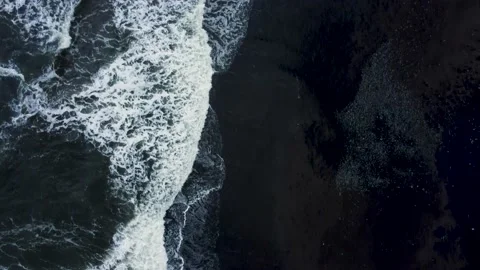 Top down vies waves on the black sand beach Stock Footage 157905231