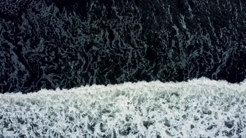 Top down vies waves on the black sand beach Stock Footage 158097620