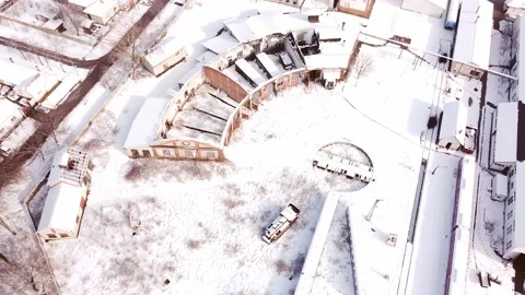 Top down view of abandoned railway depot. Train garage covered by snow. Stock Footage 149824571