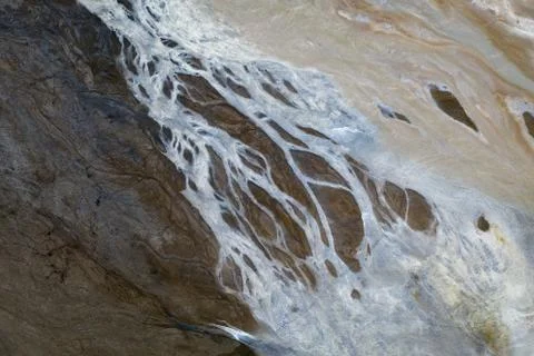 Top down view on abstract patterns and shapes of mineral waste rivers from po Stock Photos