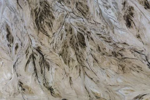 Top down view on abstract patterns and shapes of mineral waste rivers from po Stock Photos