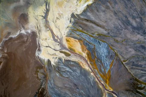 Top down view on abstract patterns and shapes of mineral waste rivers from po Stock Photos