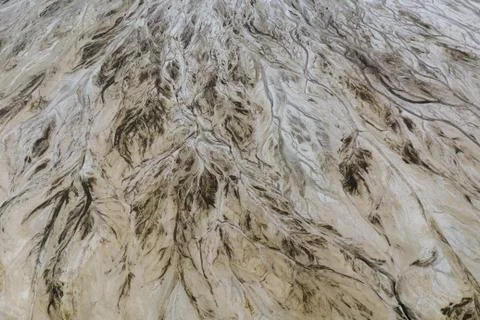 Top down view on abstract patterns and shapes of mineral waste rivers from po Stock Photos