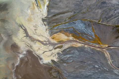 Top down view on abstract patterns and shapes of mineral waste rivers from po Stock Photos
