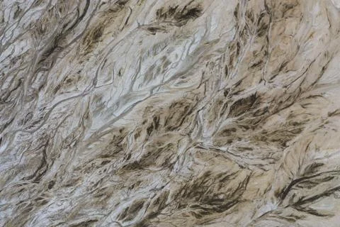 Top down view on abstract patterns and shapes of mineral waste rivers from po Stock Photos