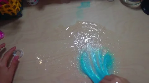 Top Down View of Activating PVA Glue Slime with Contact Lens Solution Activator Stock Footage 342336413