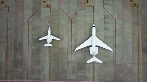 Top down view of airplanes parked on airport. Aerial view of parked airplanes at Stock Footage 144418634
