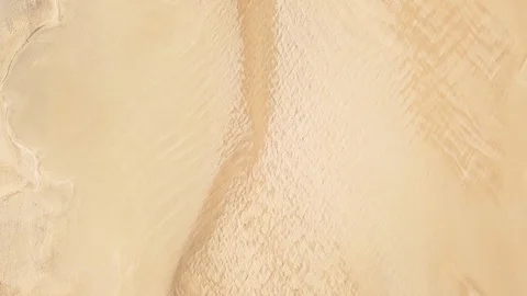 Top down view of amazing coastline following a shallow lagoon Stock Footage 127994320