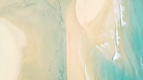 Top-down view of amazing crystal clear blue ocean water on the coastline Stock Footage 127994518