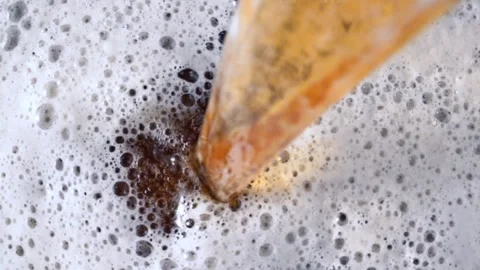 Top Down View of Amber Beer Pouring into Thick White Foam Stock-Footage 342969609