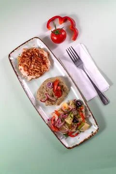 Top-down view of an appetizer platter with roasted chicken, puree dip, Stock Photos