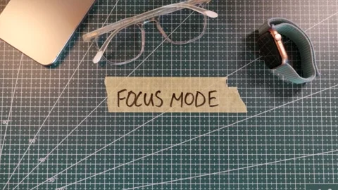 Top down view of applying FOCUS MODE handwritten tape near smartphone. Stock Footage 338183765