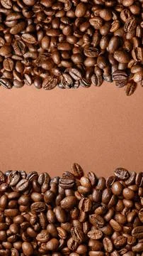 A top-down view of aromatic roasted coffee beans forming a top and bottom b.. Stock Photos