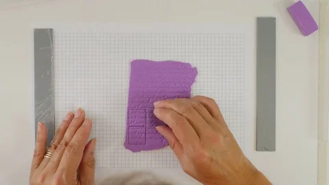 Top down view of artiest cutting out clay shapes from soft polymer clay Stock Footage 77931713