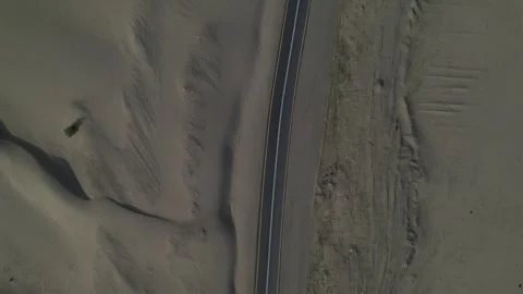 Top-down view of asphalt tracks in the sand. highway in the middle of the desert Stock Footage 263277565