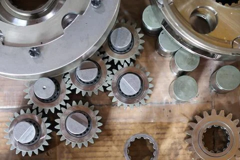 Top-down view of assorted industrial metal gears and mechanical parts. Stock Photos