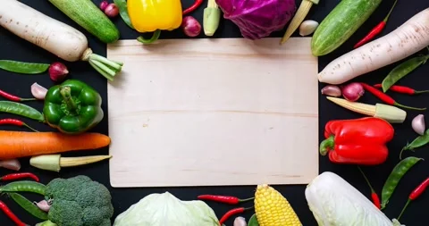 \Top Down View of Assorted Raw Vegetables and Wooden Cutting Board Stock-Footage 337513985