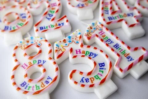 Top-down view of an assortment of colorful number-shaped birthday candles a.. Stock Photos