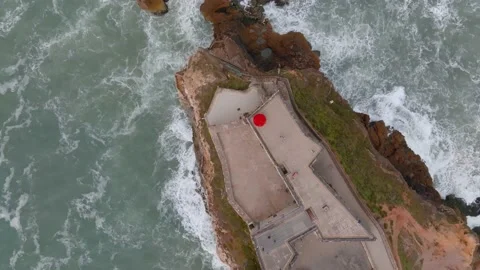 Top down view of Atlantic waves crashing in Sao Miguel Fort in Nazare, Port.. Stock Footage 239934426