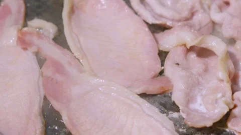 Top Down View of Bacon Sizzling in Hot Pan Cooking Outside with Steam Rising Stock Footage 341663837