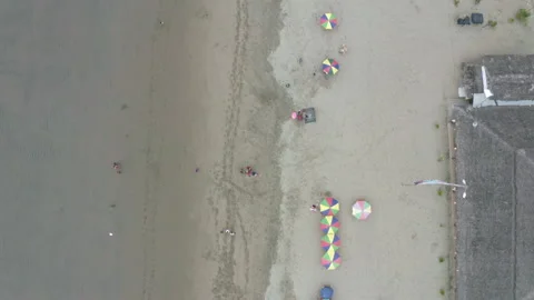 Top down view of a beach with colorful parasols and tourists relaxing Stock Footage 169903435