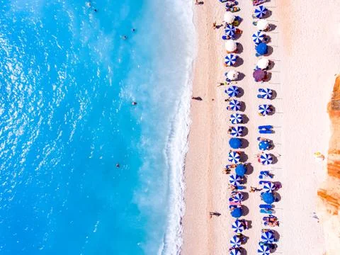 Top down view of a beach with tourists suntbeds and umbrellas with sand beach Stock Photos