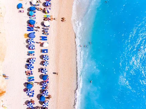 Top down view of a beach with tourists suntbeds and umbrellas with sand beach Stock Photos