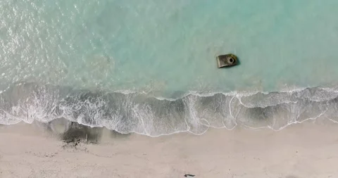 Top down view of Beach, turquoise water in ocean. Unrecognizable person walking Stock Footage 191702052