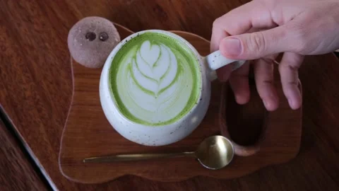 Top down view of a beautifully served cup of matte green tea with an ingenious Video stock 216699275