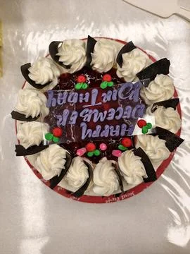 Top-down view of a Black Forest cake with "Happy December Birthday" icing Stock Photos