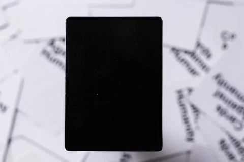 Top down view of a blank black card with white background out of focus. Unrec Stock Photos