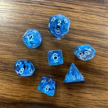 Top-Down View of Blue Polyhedral Dice on Wood Surface Stock Photos